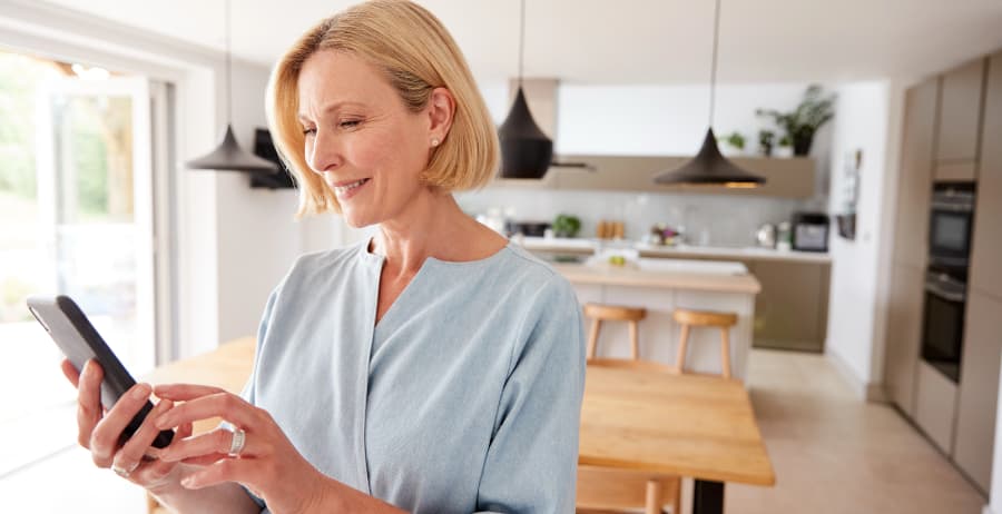 Woman with mobile device in a modern home